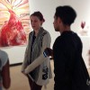 Artist Courtney Heiser stands in the Gatov Gallery at the CSULB School of Art and discusses her work with students visiting the gallery.