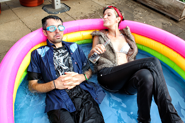 Franco & Eva Mattes, clothed, in an inflatable swimming pool