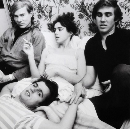 May 1, 1965: Andy Warhol, Edie Sedgwick, Chuck Wein & Gerard Malanga in bed in a Paris hotel while waiting for Warhol’s Flowers show to open at Gallery Sonnabend.