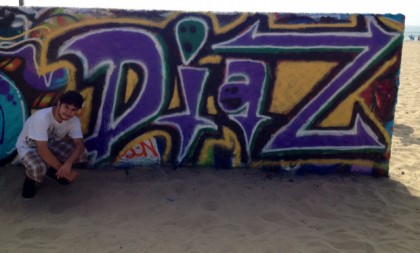 the name "Diaz" in geometric purple lettering with white and black outlining as painted by Anthony Diaz at the Venice Beach Artwalls in Venice Beach, CA