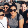 5 college women, 3 in big, dark sunglasses, stand on the beach at Venice Beach, CA and take a summer selfie