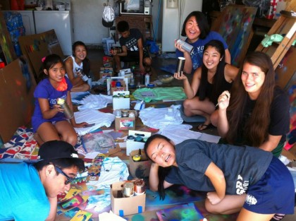 a group of kids in a garage working on art projects