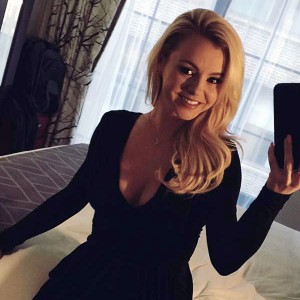 Bree Olson in a black dress taking an Instagram selfie
