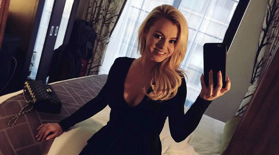 Bree Olson in a black dress taking an Instagram selfie